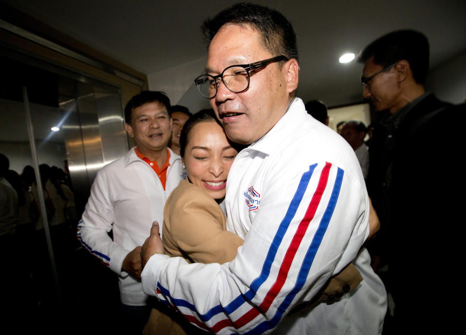 Supporter hugs Palang Pracharat Party leader Uttama Savanayana, right, after press conference at Palang Pracharat Party Bangkok, Thailand, Sunday, March 24, 2019. A military-backed party has taken the lead in Thailand's first election since a 2014 coup, preliminary results showed Sunday, suggesting junta leader and Prime Minister Prayuth Chan-ocha could stay in power.(AP Photo/Sakchai Lalit)