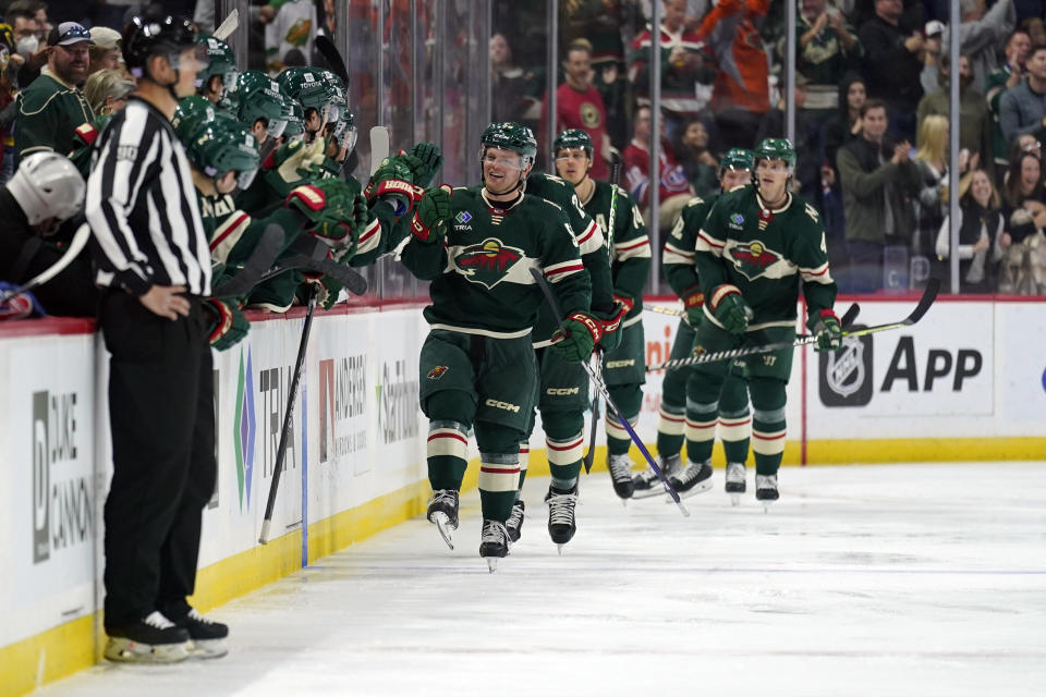 Minnesota Wild center Mason Shaw (58) celebrates with teammates after scoring a goal during the second period of an NHL hockey game against the Montreal Canadiens, Tuesday, Nov. 1, 2022, in St. Paul, Minn. (AP Photo/Abbie Parr)