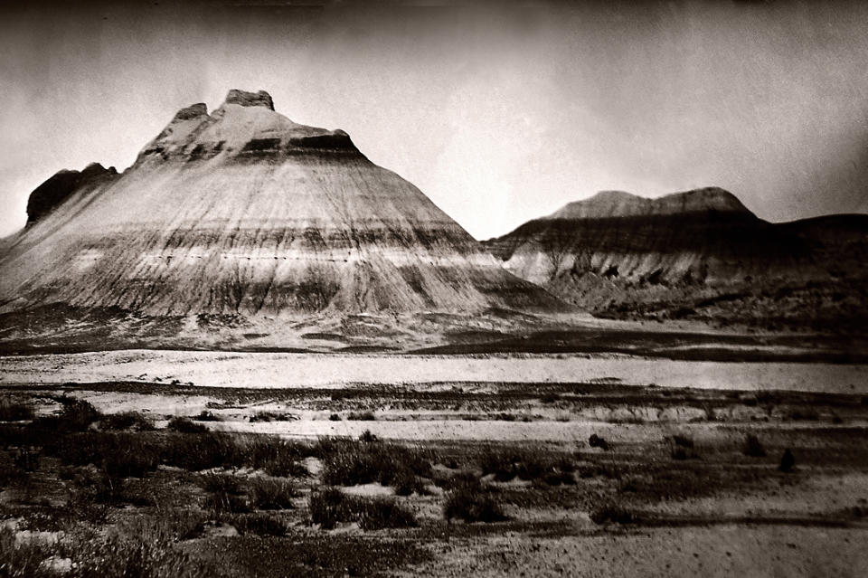 This photo provided by Studio Q shows "Skull Valley Massacre, 1864," an image by Quinn Jacobson that he took this month at Teepee Mountain in a valley West of Prescott, Ariz., where a group of Yavapai families were massacred by soldiers. Wet plate collodion photography, invented in 1851, has experienced a resurge in recent years as photographers turn to this antiquated method for its moody, even haunting, images and complicated, hands-on process. "The aesthetic is kind of a half-remembered dream," says Jacobson, a Denver photographer. Jacobson, who is part Navajo, is documenting the sites where troops massacred Native Americans during the mid- to late 1800s. (AP Photo/ Studio Q, Quinn Jacobson)