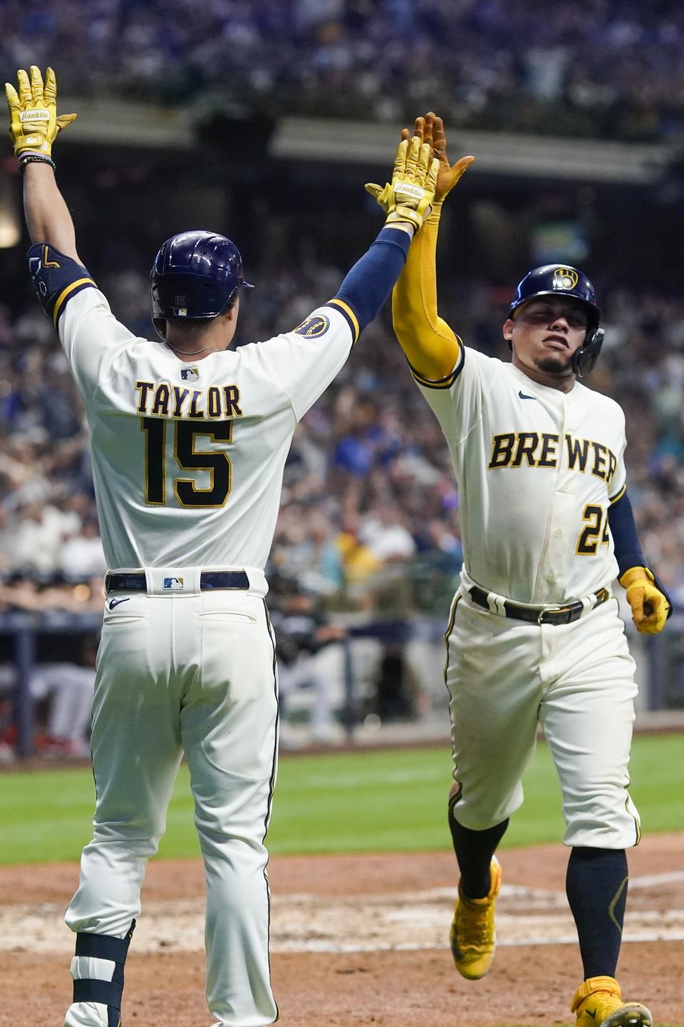 Milwaukee Brewers' William Contreras is congratulated by Tyrone Taylor after scoring during the sixth inning of a baseball game against the Minnesota Twins Tuesday, Aug. 22, 2023, in Milwaukee. (AP Photo/Morry Gash)