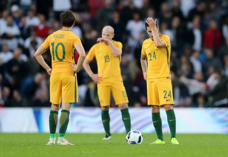 Britain Football Soccer - England v Australia - International Friendly - Stadium of Light, Sunderland - 27/5/16 (L - R) Australia's Robbie Kruse, Aaron Mooy and Jamie MacLaren look dejected after Wayne Rooney (not pictured) scores the second goal for England Reuters / Russell Cheyne