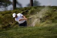 U.S. team member Rickie Fowler hits out of a bunker on the third hole during the opening foursome matches of the 2015 Presidents Cup golf tournament at the Jack Nicklaus Golf Club in Incheon, South Korea, October 8, 2015. REUTERS/Kim Hong-Ji