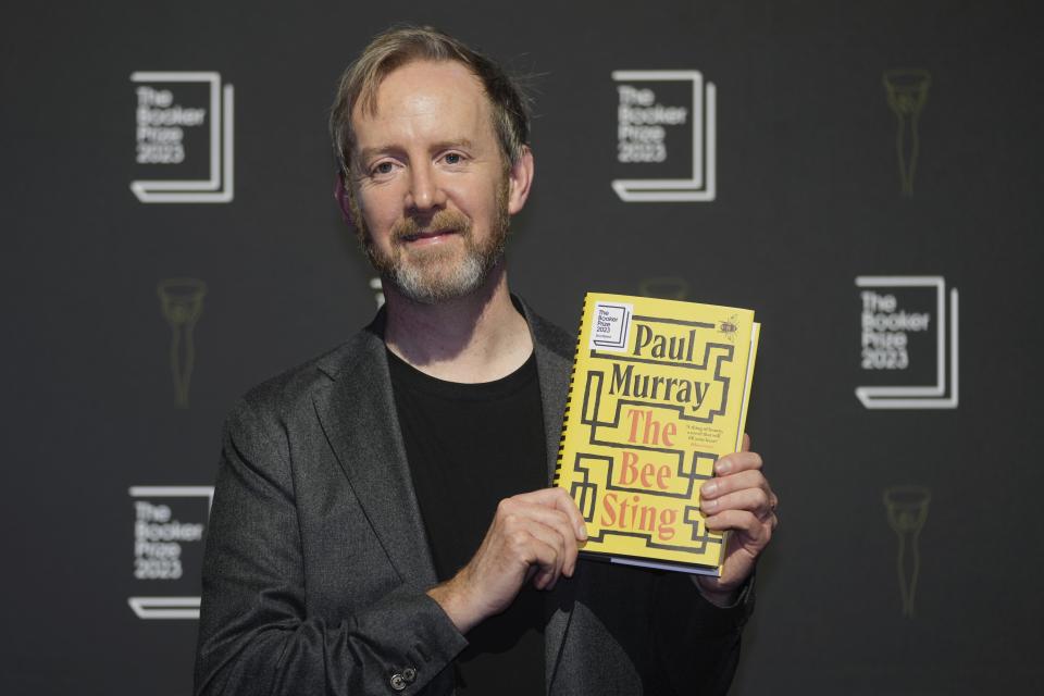 FILE - Irish author Paul Murray poses with his book "The Bee Sting" during a photocall for the Booker Prize 2023, in London on Nov. 23, 2023. (AP Photo/Kin Cheung, File)