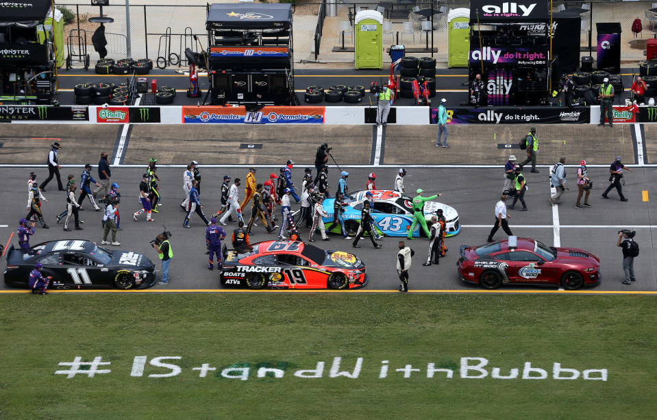 TALLADEGA, ALABAMA - JUNE 22:  NASCAR drivers push the #43 Victory Junction Chevrolet, driven by Bubba Wallace, to the front of the grid as a sign of solidarity with the driver prior to the NASCAR Cup Series GEICO 500 at Talladega Superspeedway on June 22, 2020 in Talladega, Alabama. A noose was found in the garage stall of NASCAR driver Bubba Wallace at Talladega Superspeedway a week after the organization banned the Confederate flag at its facilities. (Photo by Brian Lawdermilk/Getty Images)