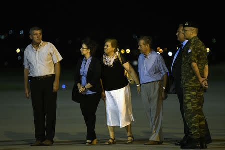 The parents of Angelos Mitretodis and Dimitris Kouklatzis, two Greek soldiers who were detained in Turkey after crossing the border, the Chief of the Hellenic Army Lieutenant General Alikiviadis Stefanis and Greek Defense Minister Panos Kammenos wait for the soldiers' arrival after they were released, at the airport of Thessaloniki, Greece, August 15, 2018. REUTERS/Alexandros Avramidis