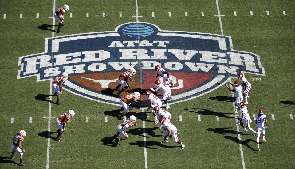 FILE - Oklahoma, right, runs a play against Texas in the first half of an NCAA college football game at the Cotton Bowl in Dallas, Oct. 12, 2019. The Big 12 is losing its marquee matchup when the Red River Rivalry is played Saturday for the final time under the league’s umbrella. (AP Photo/Jeffrey McWhorter, File)