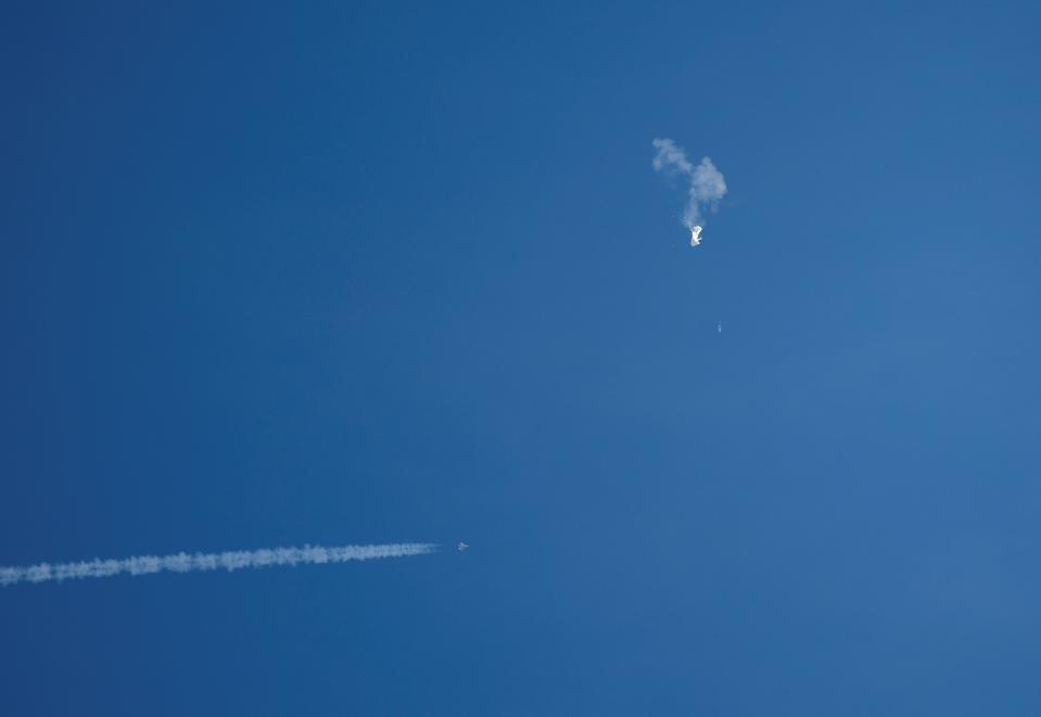 A jet flies by a suspected Chinese spy balloon after shooting it down off the coast in Surfside Beach, South Carolina, U.S. February 4, 2023 (REUTERS)