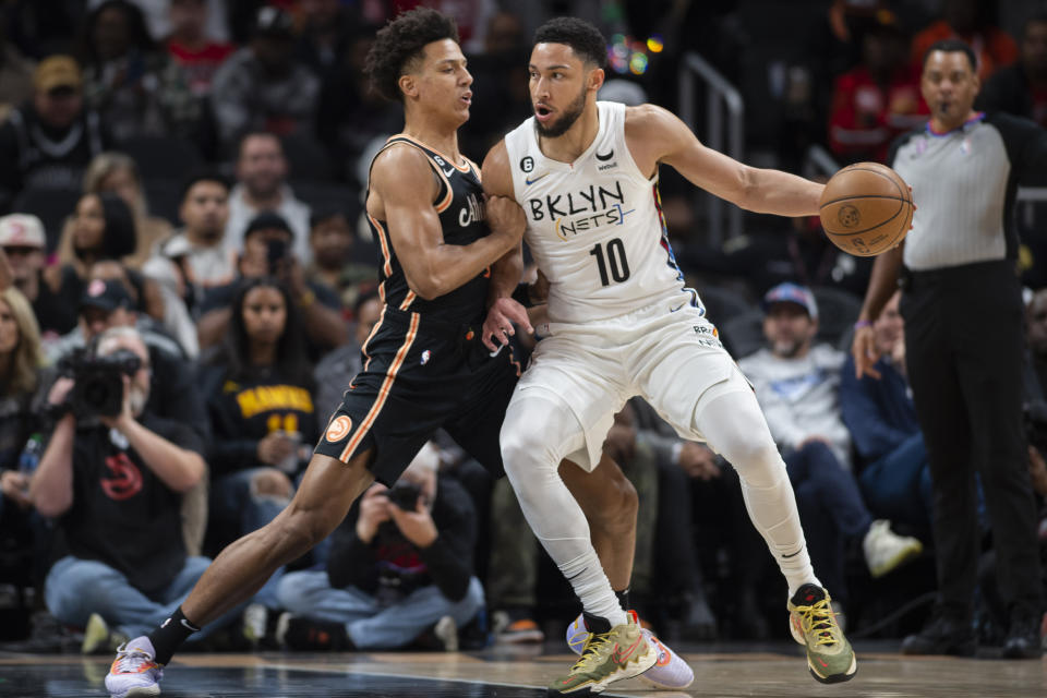 Brooklyn Nets guard Ben Simmons (10) dribbles against Atlanta Hawks forward Jalen Johnson during the first half of an NBA basketball game, Wednesday, Dec. 28, 2022, in Atlanta. (AP Photo/Hakim Wright Sr.)