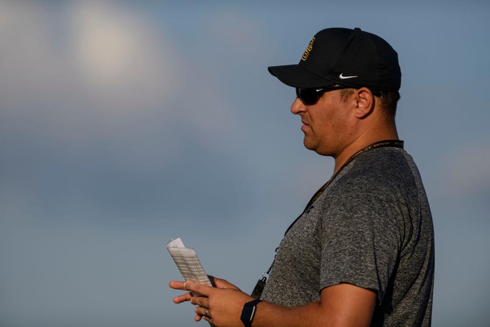 Head Coach Nick Hart watches his football team practice at Gibson Southern High School in Fort Branch, Ind., Tuesday evening, Aug. 3, 2021.