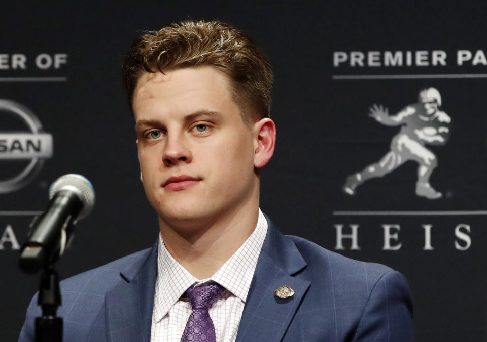 File-This Dec. 14, 2019, file photo shows NCAA college football player and Heisman Trophy finalist, LSU quarterback Joe Burrow listening to questions from the media during a news conference before the Heisman Trophy ceremony in New York. Burrow is a hero on LSU's Baton Rouge campus, but he hasn't seen much of it because he took graduate courses online. (AP Photo/Jason Szenes,File)