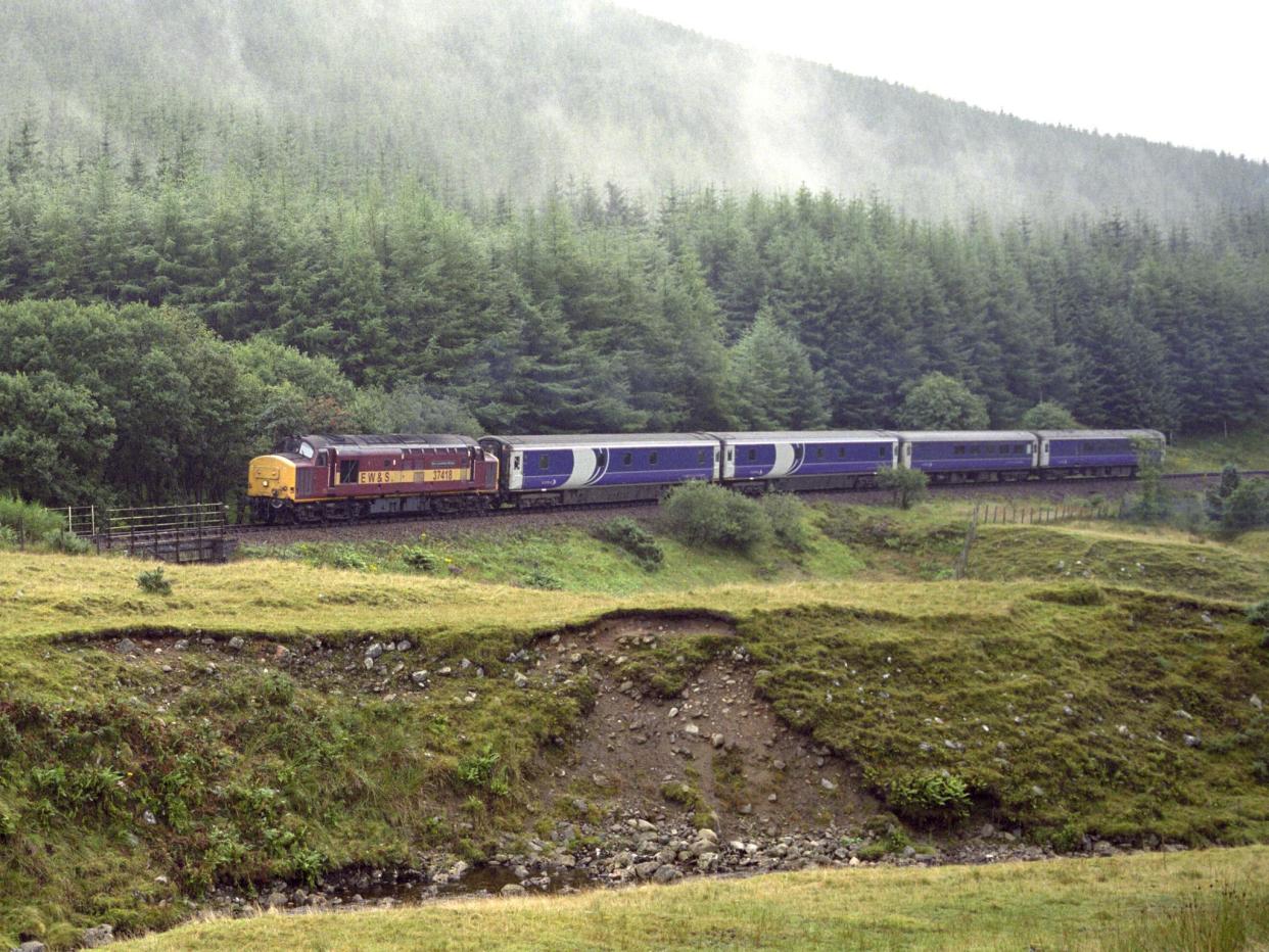 Caledonian Sleeper from London Euston Station approaching the Horseshoe Curve on the West Highland Line (Getty)