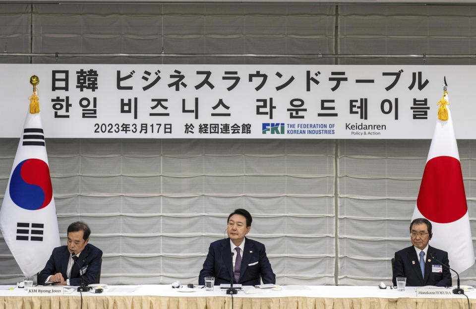 South Korea's President Yoon Suk Yeol, center, joins Masakazu Tokura, right, chairman of Keidanen, the Japan Business Federation, and Kim Byong-joon, acting chairman of the Federation of Korean Industries, as they attend a Japan-Korea business roundtable meeting in Tokyo on March 17, 2023. (Philip Fong/Pool Photo via AP)