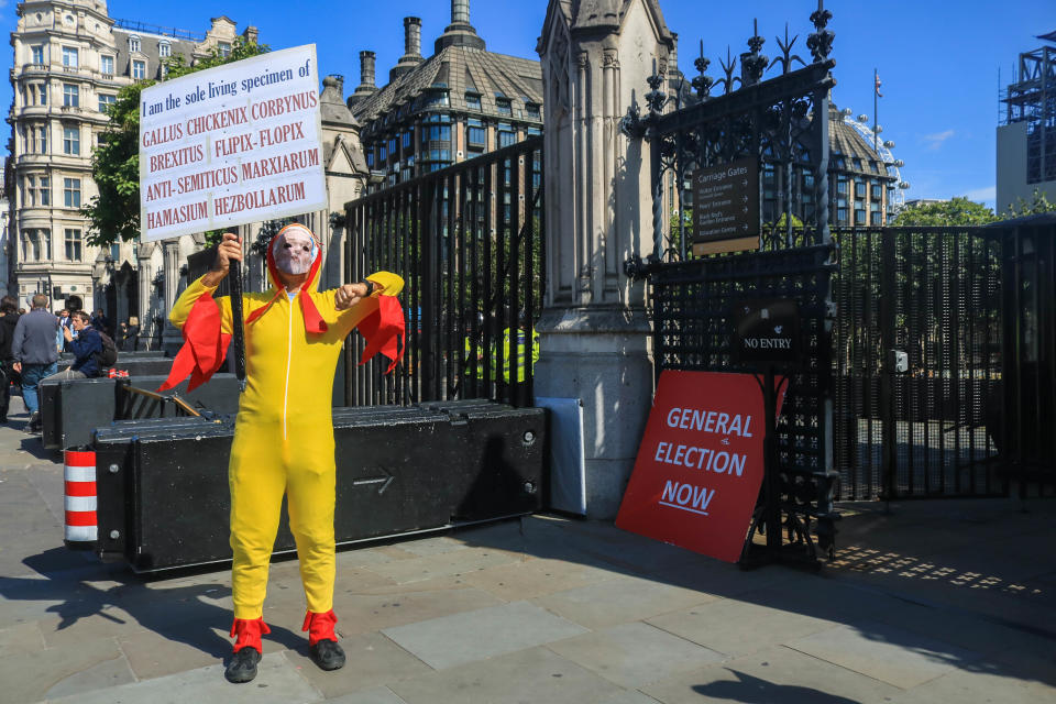 A protester dressed in a chicken costume outside the gates of Parliament mocking Labour leader Jeremy Corbyn who was called chicken at PMQ's by Prime Minister Boris Johnson  for not agreeing to hold a general election (Photo credit should read Amer Ghazzal / Barcroft Media via Getty Images)