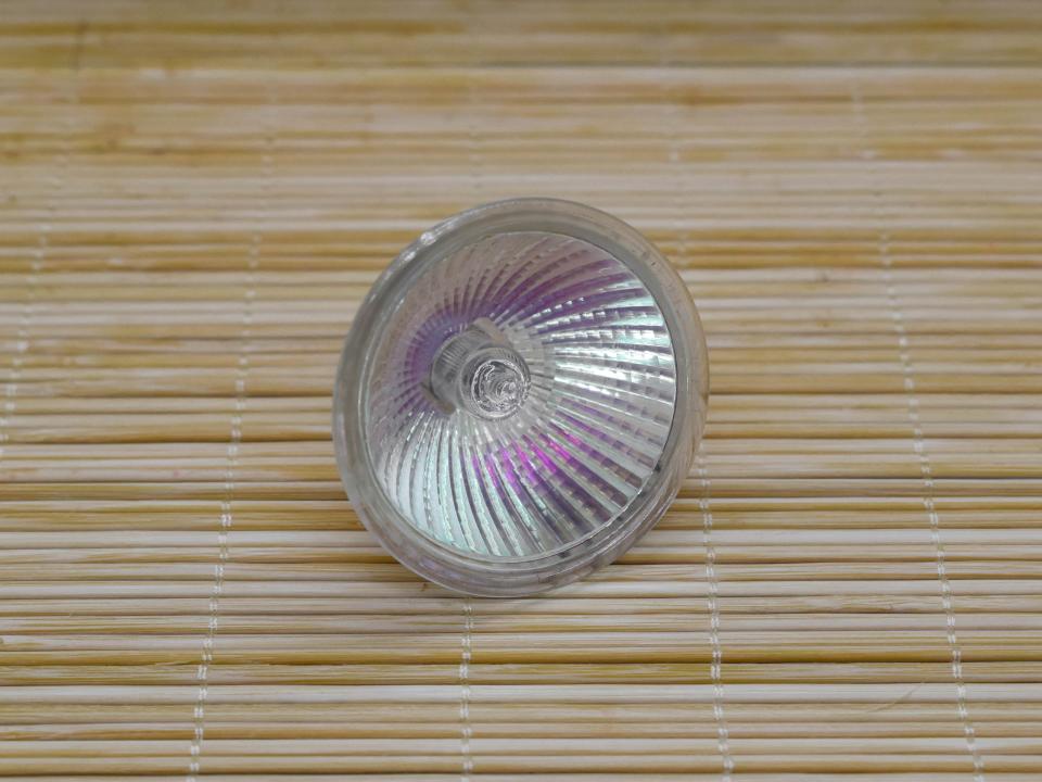 A halogen light bulb on bamboo background