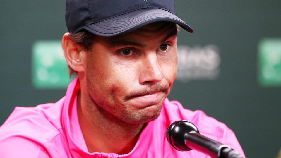 Rafael Nadal speaks to the media after withdrawing from his semi-final match against Roger Federer. (Photo by Yong Teck Lim/Getty Images)