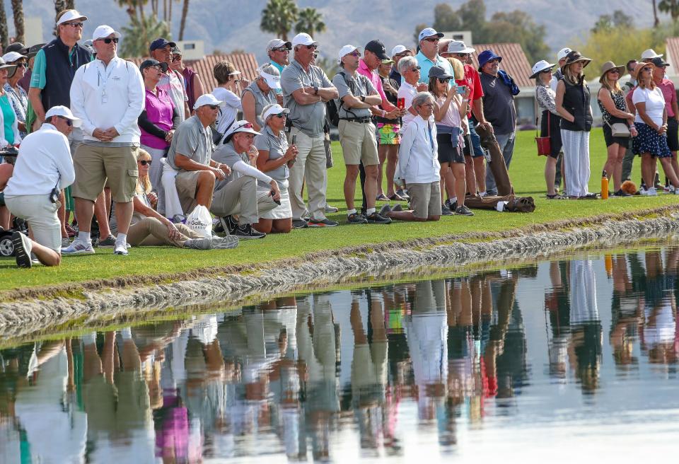 The gallery watches the final group putt on the 18th hole during the Galleri Classic at Mission Hills Country Club in Rancho Mirage, March 26, 2023.  