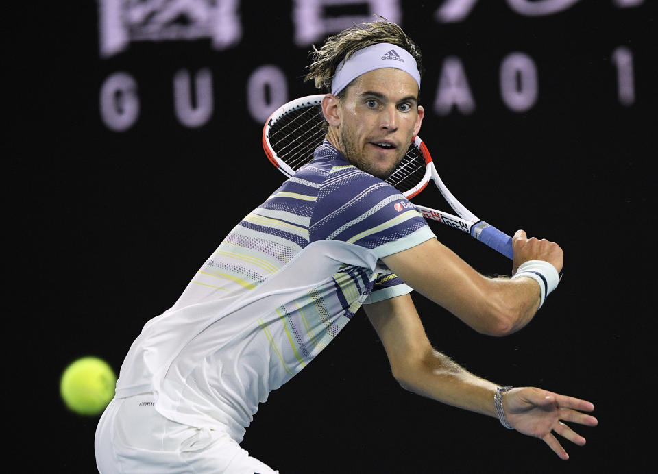 Austria's Dominic Thiem makes a backhand return to Spain's Rafael Nadal during their quarterfinal match at the Australian Open tennis championship in Melbourne, Australia, Wednesday, Jan. 29, 2020. (AP Photo/Andy Brownbill)