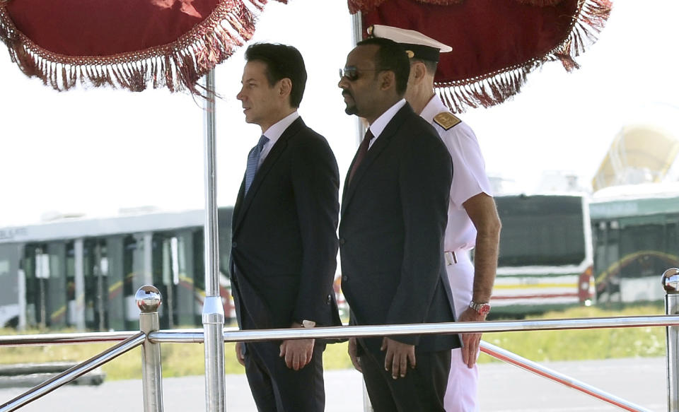 Italian Premier Giuseppe Conte, left, and Ethiopian Prime Minister Abiy Ahmed Ali stand attention at they review the guard of honor, in Addis Ababa, Ethiopia on the occasion of an official visit, Thursday Oct. 11, 2018. (AP Photo)