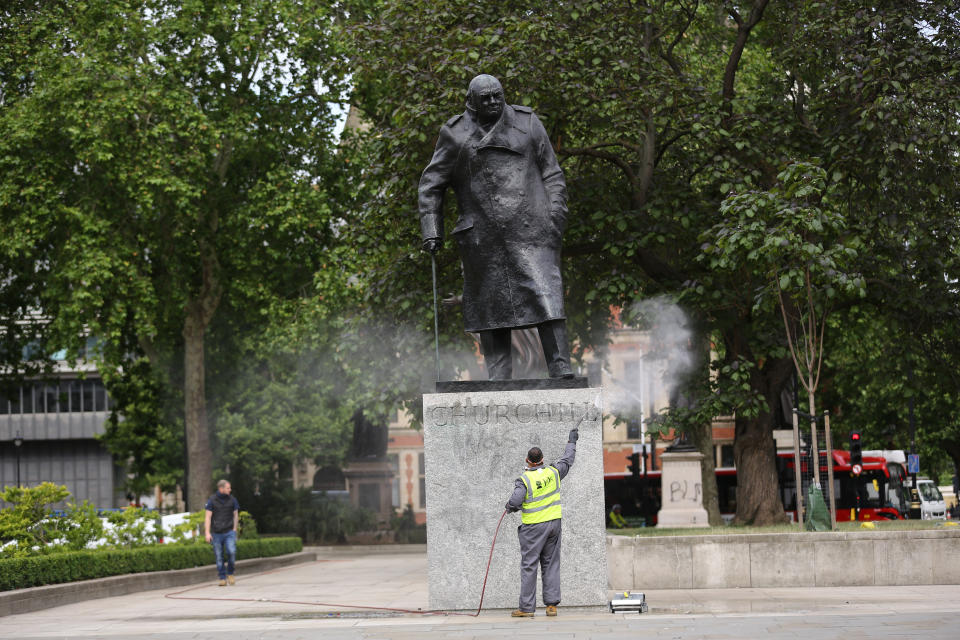 A worker cleans graffiti from the plinth of the statue of Sir Winston Churchill at Parliament Square in London, following a Black Lives Matter protest at the weekend. A raft of protests across the UK were sparked by the death of George Floyd, who was killed on May 25 while in police custody in the US city of Minneapolis.