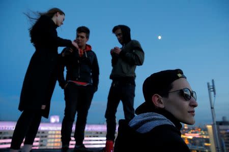 A group of young people gather on a rooftop in Moscow, Russia, June 2, 2017. REUTERS/Maxim Shemetov