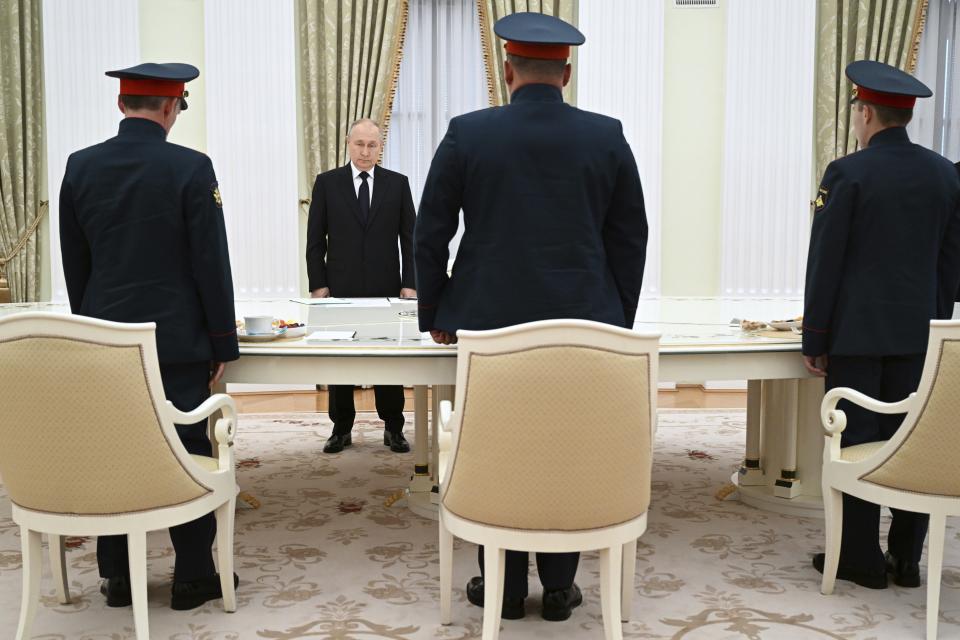 FILE - Russian President Vladimir Putin, background center, greets servicemen, participants of Russian special military operation prior to their talks at the Kremlin in Moscow, Russia, on Sept. 29, 2023. Putin on Friday Dec. 8, 2023 moved to prolong his repressive and unyielding grip on Russia for another six years, announcing his candidacy in the 2024 presidential election that he is all but certain to win. (Pavel Bednyakov, Sputnik, Kremlin Pool Photo via AP, File)