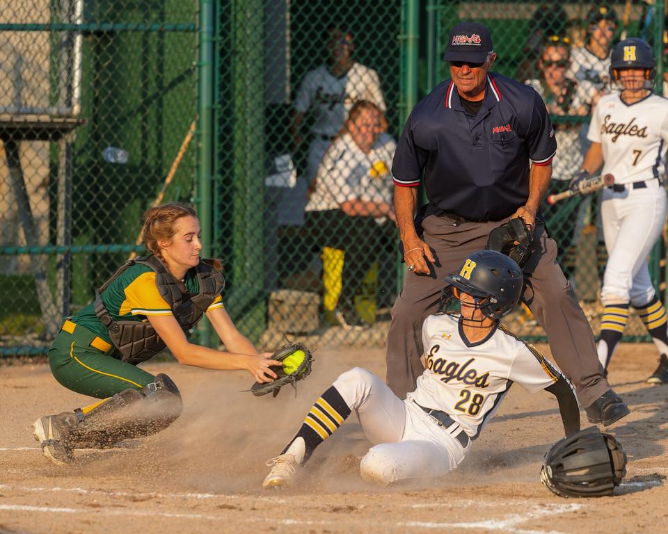 Hartland's Skylar Spisz slides home with the first run of the game in the Eagles' 3-0 Division 1 quarterfinal victory over Gross Pointe North Wednesday, June 14, 2024 at Wayne State University.