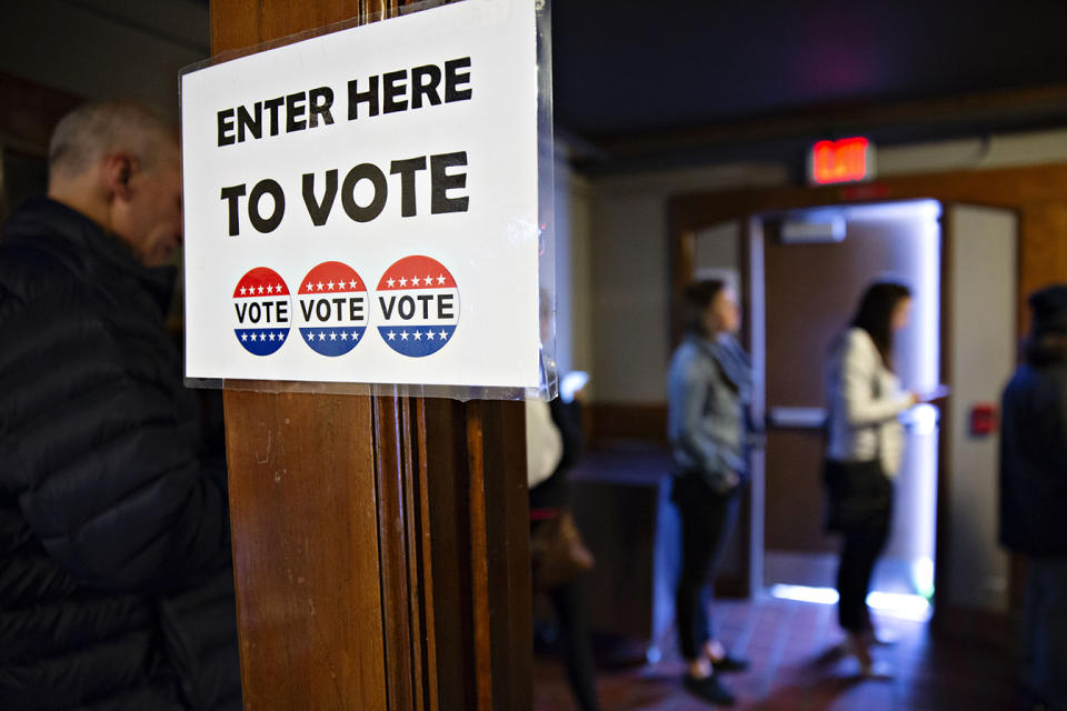 Voters wait in line to cast ballots at a polling station. (Credit: Daniel Acker/Bloomberg via Getty Images)
