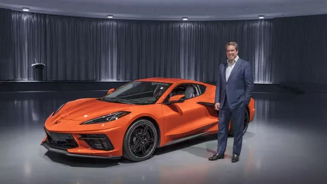 gm president mark reuss with orange c8 corvette