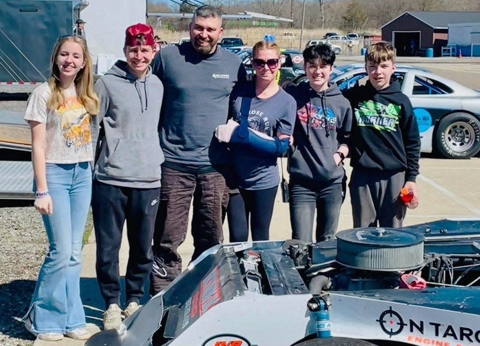 Jeremy Vanderhoof gathers around one of his cars with his family on race day. The Temperance man says his entire family contributes to his success at Flat Rock and Toledo Speedways. He will be racing against his oldest son Avery in Figure 8s this summer.
