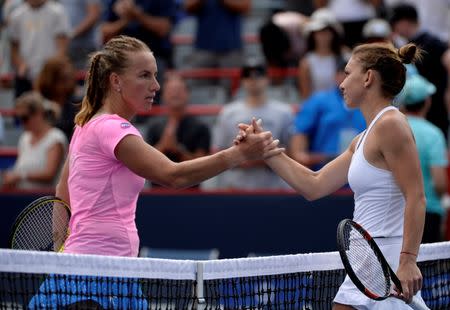 Jul 29, 2016; Montreal, Quebec, Canada; Svetlana Kuznetsova of Russia (left) and Simona Halep of Romania shake hands after their match on day five of the Rogers Cup tennis tournament at Uniprix Stadium. Halep defeated Kuznetsova. Mandatory Credit: Eric Bolte-USA TODAY Sports