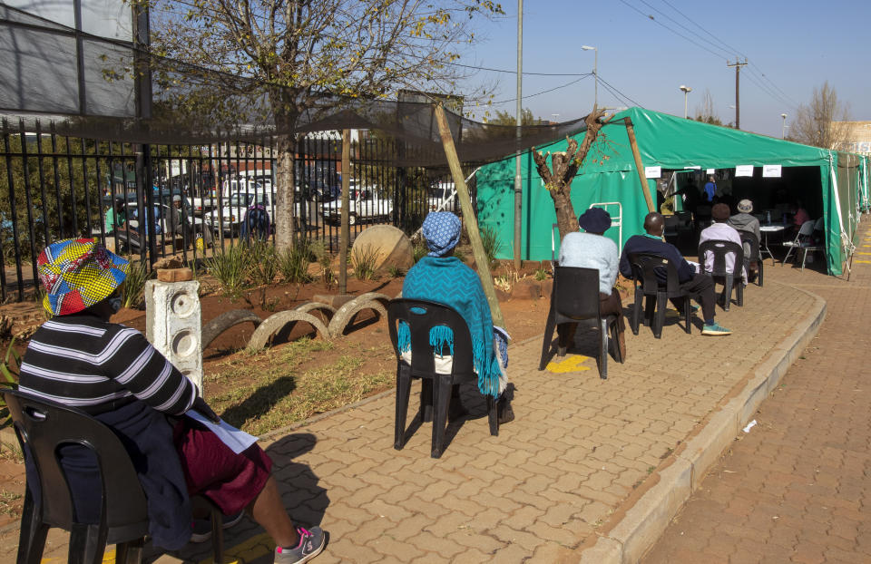 Retirees wait to receives a first dose of the Pfizer coronavirus vaccine in a tent during a mass vaccination program for the elderly at the clinic outside Johannesburg, South Africa, Monday, May 24, 2021. South Africa is in a race against time to vaccinate as many people as possible with signs the virus may be surging again. (AP Photo/Themba Hadebe)