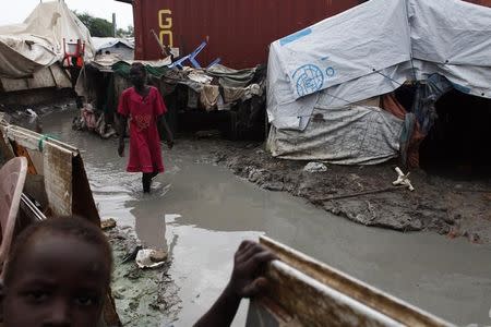 A girl walks through mud in the internally displaced persons (IDP) camp inside the United Nations base in Malakal July 23, 2014. REUTERS/Andreea Campeanu/Files