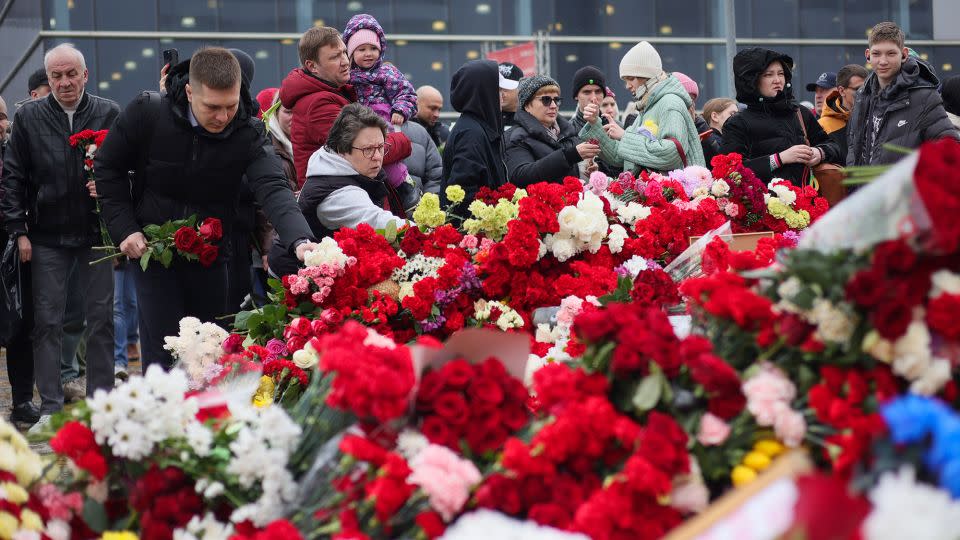 People place flowers at a memorial outside Crocus City Hall in Moscow on Sunday.  - Vitaly Smolnikov/AP