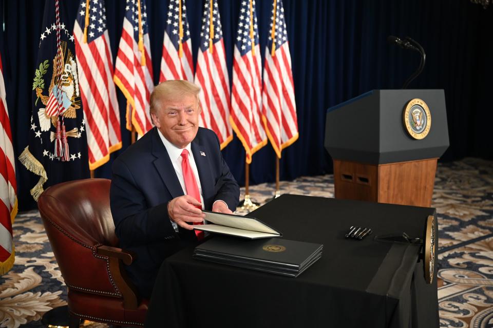 US President Donald Trump signs executive orders extending coronavirus economic relief, during a news conference in Bedminster, New Jersey, on August 8, 2020. (Photo by JIM WATSON / AFP) (Photo by JIM WATSON/AFP via Getty Images)
