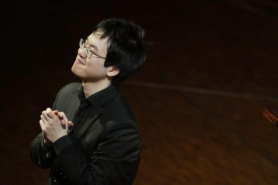 Canadian pianist Eric Guo thanks the audience after performing Frederic Chopin's Concerto in F minor on a replica of a 1830 Pleyel piano during a concert marking the 19th century piano virutoso and composer's 214th birthday, in Warsaw, Poland, on Friday, March 1, 2024. Guo won a quintannual competition to play Chopin on period instruments organized by the Fryderyk Chopin Institute. (AP Photo/Czarek Sokolowski)