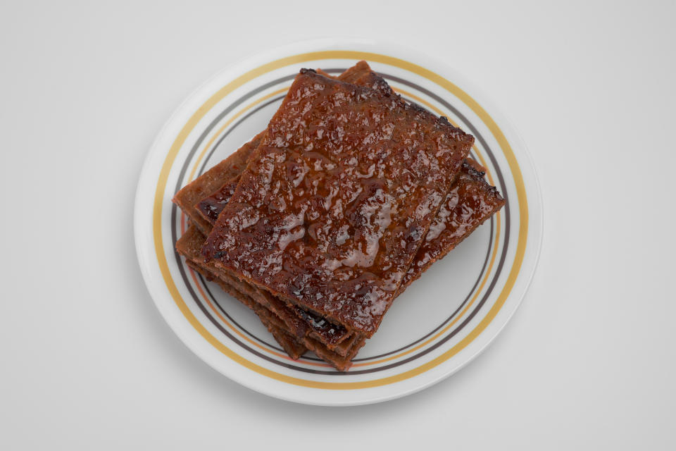 Pork jerky known as bak kwa in Chinese, served on a plate.