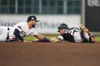 Chicago White Sox's Andrew Benintendi, right, slides into second for a double as Houston Astros second baseman David Hensley applies the late tag during the sixth inning of a baseball game Friday, March 31, 2023, in Houston. (AP Photo/Eric Christian Smith)