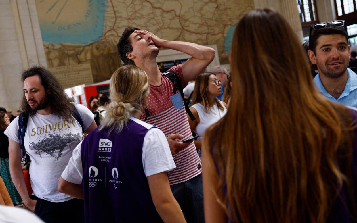 Passengers react inside Gare de Bordeaux Saint-Jean station