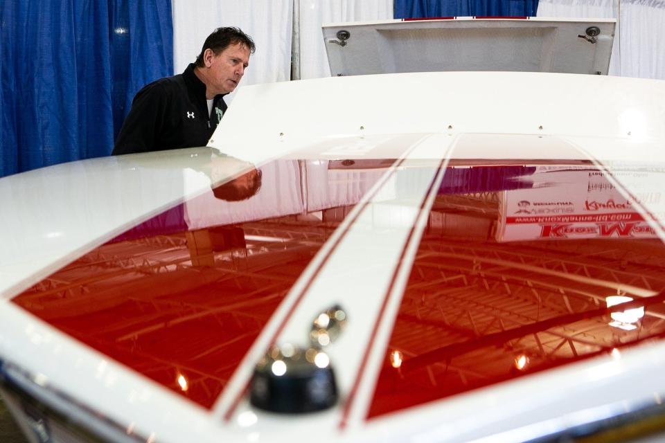 Jeff Layne from Bellville, near Marion, Ohio, checks the interior of a Sutphen SS closed bow boat from Alexander's Landing, of Millersport, at Buckeye Lake during the 42nd annual Ohio RV & Boat Show on Saturday.