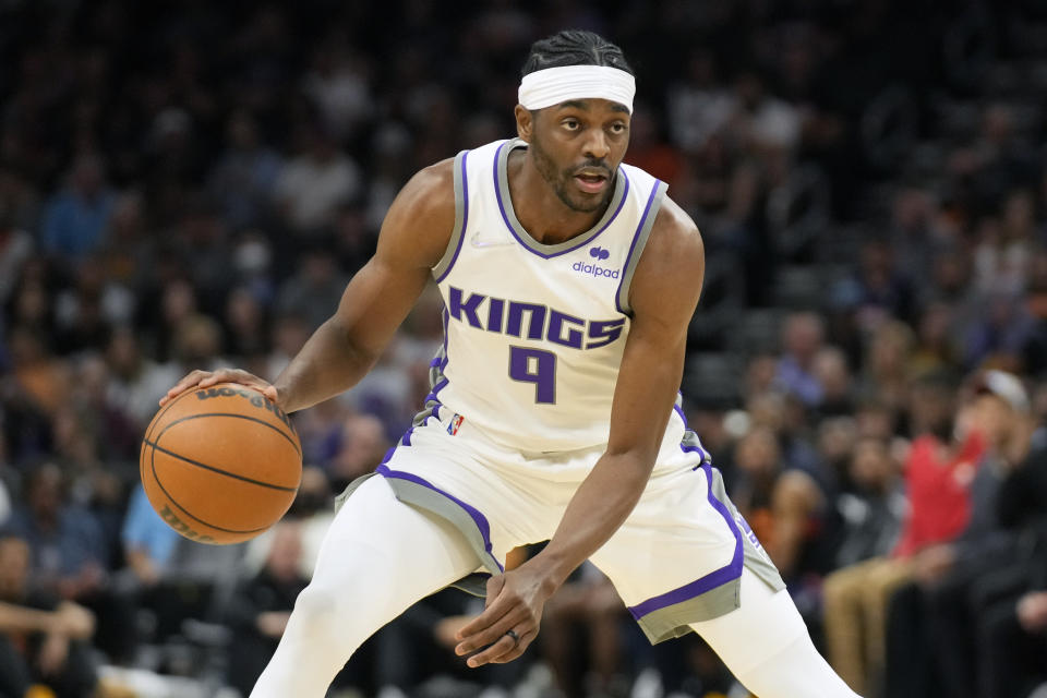 FILE - Sacramento Kings forward Justin Holiday (9) plays during the first half of an NBA basketball game against the Phoenix Suns, Sunday, April 10, 2022, in Phoenix. The Atlanta Hawks are trading Kevin Huerter to the Sacramento Kings for Justin Holiday, Mo Harkless and a future conditional draft pick, according to a person with direct knowledge of the agreement. The person spoke to The Associated Press on condition of anonymity Friday, July 1, 2022, because the trade had not been formally approved by the NBA and announced by either club. (AP Photo/Rick Scuteri, File)