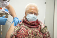 Wilfriede Niehoff receives a vaccination against the COVID-19 disease in Osnabueck, Germany, Saturday, Nov. 13, 2021. Germany has struggled to bring new momentum to its vaccination campaign lately, with a bit over two-thirds of the population fully vaccinated, and has balked so far at ordering vaccine mandates for any professional group. (Lino Mirgeler/dpa via AP)