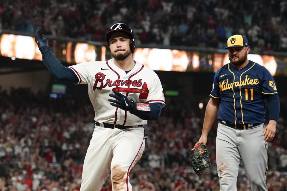 Atlanta Braves' Huascar Ynoa (19) reacts after a Atlanta Braves' Travis d'Arnaud hit a RBI single against the Milwaukee Brewers during the fifth inning of Game 4 of a baseball National League Division Series, Tuesday, Oct. 12, 2021, in Atlanta. (AP Photo/John Bazemore)