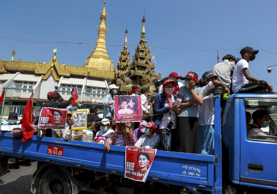 Demonstrators hold pictures of deposed Myanmar leader Aung San Suu Kyi to protest against the military coup in Yangon, Myanmar Wednesday, Feb. 17, 2021. Demonstrators in Myanmar gathered Wednesday in their largest numbers so far to protest the military’s seizure of power, as a U.N. human rights expert warned that troops being brought to Yangon and elsewhere could signal the prospect for major violence. (AP Photo)