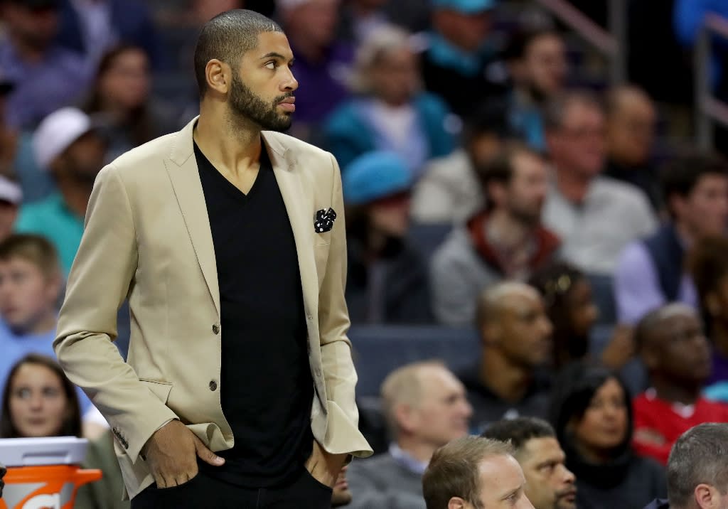 Nicolas Batum of the Charlotte Hornets watches on from the bench against the Orlando Magic during their game at Spectrum Center on October 29, 2017 in Charlotte, North Carolina