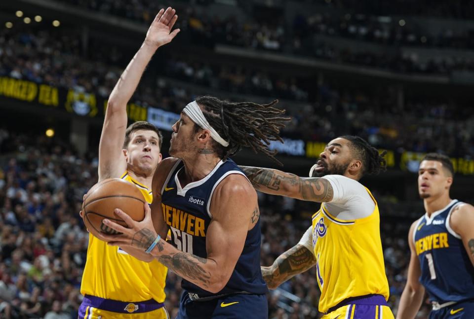 Nuggets forward Aaron Gordon drives past Lakers guards Austin Reaves and D'Angelo Russell during Game 5