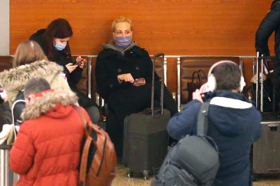 Yulia, wife of Russian opposition leader Alexei Navalny, cente, sits on a chair upon arrival at Sheremetyevo airportAP