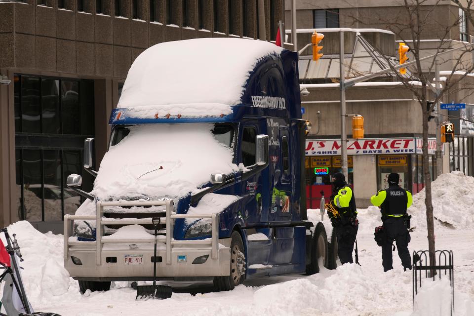 Police inspect one of the last remaining trucks in downtown Ottawa on Feb. 20, 2022. A protest, which was first aimed at a COVID-19 vaccine mandate for cross-border truckers, also encompassed fury over the range of COVID-19 restrictions.