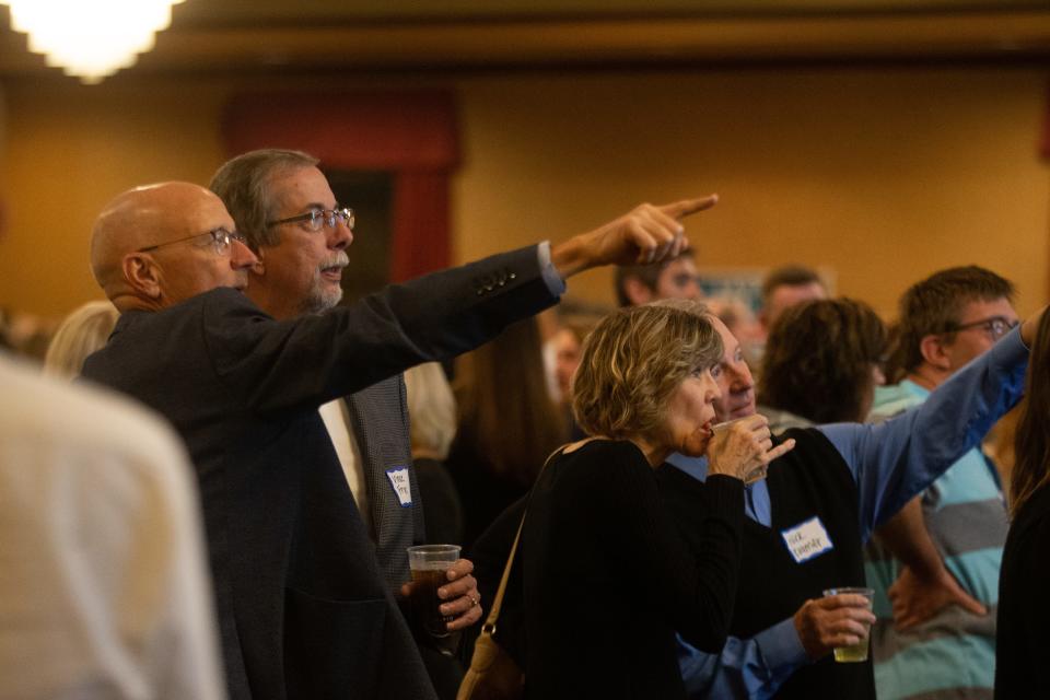 Supporters of Gov. Laura Kelly and Lt. Gov. David Toland watch results start to appear during a watch party at Topeka's Ramada Inn on Tuesday night.