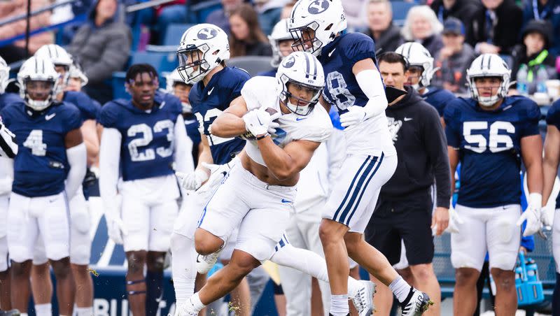 BYU Cougars running back Hinckley Ropati (7) dodges a tackle during the annual BYU Blue vs. White scrimmage at LaVell Edwards Stadium in Provo on Friday, March 31, 2023.