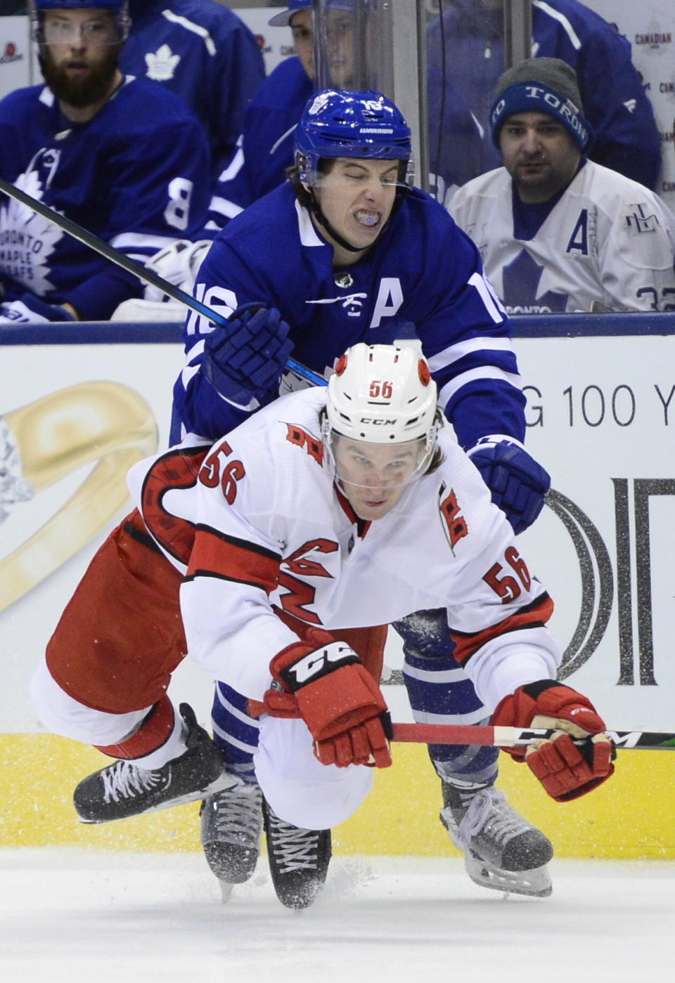 Toronto Maple Leafs right wing Mitch Marner (16) takes down Carolina Hurricanes left wing Erik Haula (56)during third period NHL hockey action in Toronto, Monday, Dec. 23, 2019. (Frank Gunn/The Canadian Press via AP)